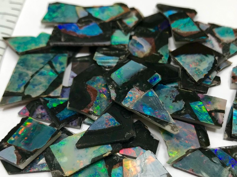 10 grams of Australian Opal on black background for making cabochons